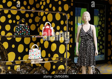 TOKYO, JAPAN - March 5, 2023: Signs and Yayoi Kusama motifs on a building  containing a Louis