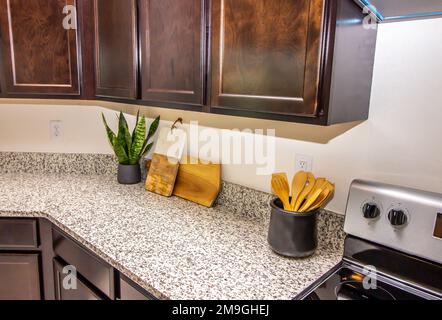 Kitchen Counter With Cutting Boards And Wooden Spoons Stock Photo