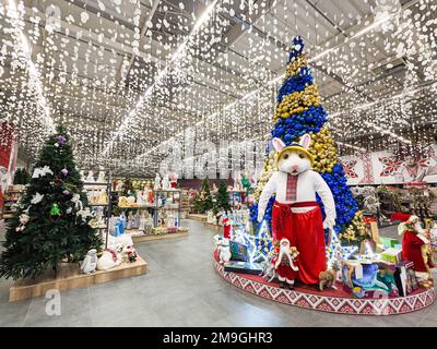 The symbol of 2023 is a large hare near the Christmas tree in the supermarket. Dnipro, Ukraine, January 6, 2023. Stock Photo