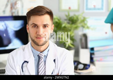Portrait of young handsome male doctor in clinic Stock Photo