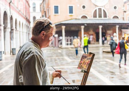 VENICE, ITALY - SEPTEMBER 23, 2019: Street artist painter in Venice, Italy. Stock Photo