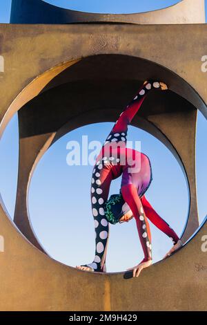 Contortionist posing in circular structure, Seattle, Washington, USA Stock Photo
