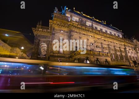 Tram speeding by National Theatre at night, Prague, Czech Republic Stock Photo
