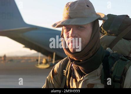 US Navy Corpsman Second Class Gartman, a member of Headquarters Company, Battalion Landing Team 3/6, 26th Marine Expeditionary Unit (Special Operations Capable) stands the flightline at Kandahar International Airport, Kandahar, Afghanistan, waiting to board a Marine Corps KC-130 from the Marine Aerial Refueling Squadron VMGR-352, on a mission in support of OPERATION ENDURING FREEDOM. Subject Operation/Series: ENDURING FREEDOM Base: Kandahar International Airport Country: Afghanistan (AFG) Scene Major Command Shown: 26th MEU (SOC) Stock Photo