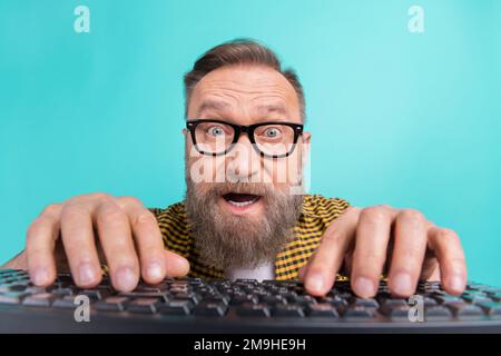 Photo of surprised shocked man web designer wear plaid clothes writing website 404 error feel young isolated on cyan color background Stock Photo