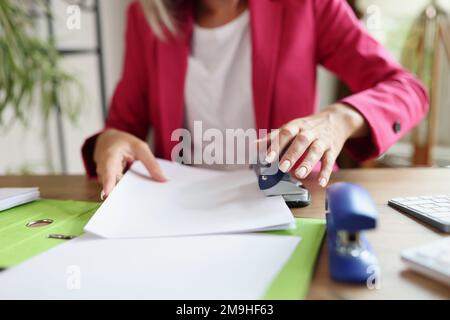 Business woman doing paperwork in office. Stock Photo
