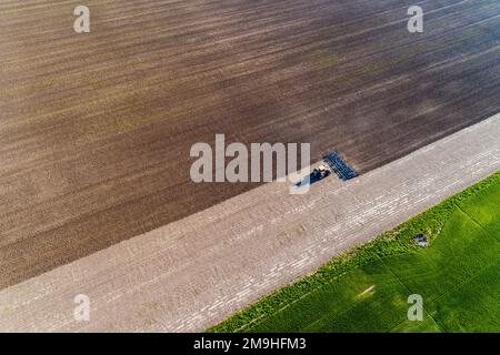 Aerial view of tractor working soil before planting, Marion County, Illinois, USA Stock Photo