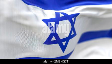 Detail of the Israel national flag waving. Blue hexagram on a white background, between two horizontal blue stripes. Rippled fabric. Textured backgrou Stock Photo