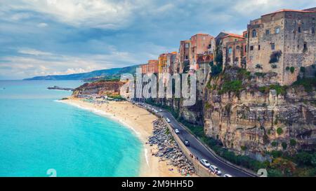 Tropea, Italy - September 10, 2019: Landscape with Tropea beach and old town buildings on mountain rock. Stock Photo