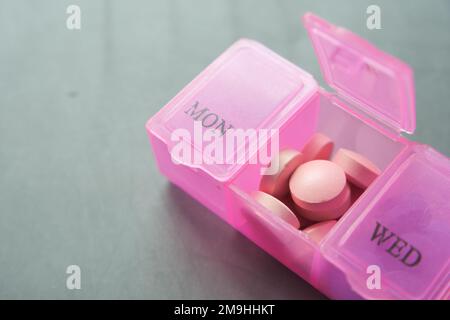 close up of medical pills in a pill box on table  Stock Photo