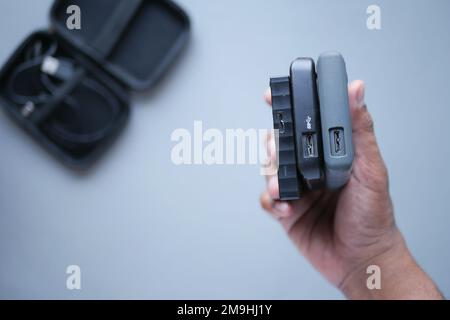 holding a stack of external hard drives  Stock Photo