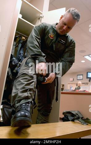 US Navy (USN) Captain (CAPT) Dan Doorman, with the Electronic Attack Squadron-133 (VAQ 133), from Woodby Island, Washington, puts on his G-suit at the Elmendorf Air Force Base (AFB), Alaska, life support section, during exercise NORTHERN EDGE 2002. Base: Eielson Air Force Base State: Alaska (AK) Country: United States Of America (USA) Stock Photo