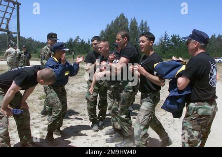 US Air Force (USAF) Security Police (SP) from the 50th Space Wing (SW), Schriever Air Force Base (AFB), Colorado (CO), are congratulated by USAF Colonel (COL) Diann Latham (center), 50th Space Wing Competition Commander, after completing the Obstacle Course competition at Vandenberg Air Force Base (AFB) California (CA), during Exercise GUARDIAN CHALLENGE 2002. Guardian Challenge, a four-day space and missile competition, is hosted annually at Vandenberg AFB, CA to test the wartime readiness of Air Force Space Command (AFSPC) professionals. US Air Force (USAF) Security Police (SP) from the 50th Stock Photo