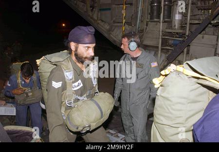 US Air Force (USAF) STAFF Sergeant John Tubbs (right), an MC-130H Combat Talon II aircraft Loadmaster assigned to the 1ST Special Operations Squadron (SOS), watches Indian Army paratroopers load into his aircraft. SSGT Tubbs and USAF personnel assigned to the 353rd Special Operations Group are (SOG) deployed for joint combined exchange training with the Indian Armed Forces, at Air Force Station Agra, India. Base: Air Force Station Agra Country: India (IND) Stock Photo