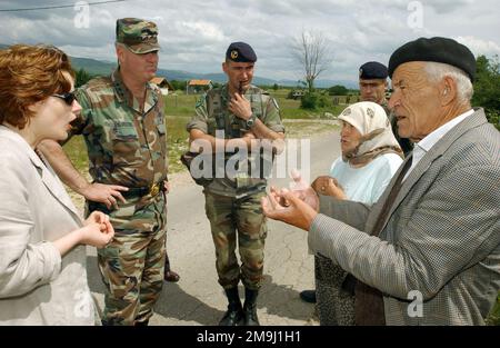 020609-F-3939J-003. [Complete] Scene Caption: US Army (USA) and French Army Officials assigned to the Stabilization Force (SFOR), conduct a interview with local Residents from the community of Nevesinjie, Bosnia-Herzegovina, to hear testimonies on how they have been treated by the local community after the six year Balkan War. Pictured left to right- Ms. Leila Dizdarevic, Interpreter; US Army (USA) Lieutenant General (LGEN) John B. Sylvester (right), Commander, Stabilization Force (SFOR); French Army Captain (CPT) Raulet Guillaume, Company Commander, 3rd Company, 21st Marine Infantry Battalion Stock Photo