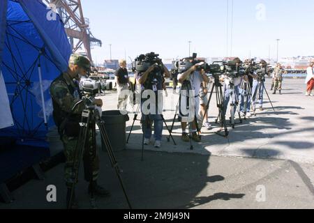 020716-F-5735S-023. [Complete] Scene Caption: US Air Force (USAF) Technical Sergeant (TSGT) Mario Muncey (foreground), a Videographer assigned to the 4th Combat Camera Squadron (CCS) sets up his camera with other members of the local civilian news media to document activities prior to the start of Exercise SEAHAWK 2002, at McChord Air Force Base (AFB), Washington, (WA). Seahawk combines active duty and reserve components from the US Air Force (USAF), US Navy (USN), US Coast Guard (USCG), US Public Health Service, Royal Canadian Armed Forces (RCAF), Federal Bureau of Investigation (FBI), Federa Stock Photo