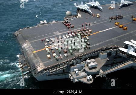 A high-angle view showing the aft flight deck aboard the US Navy (USN) Aircraft Carrier, USS JOHN F. KENNEDY (CV 67) as Ordnance Crews prepare for Underway Replenishment (UNREP), while the Kennedy and her embarked Carrier Air Wing Seven (CVW 7) are underway at sea conducting combat missions in support of Operation ENDURING FREEDOM. Subject Operation/Series: ENDURING FREEDOM Country: Unknown Stock Photo