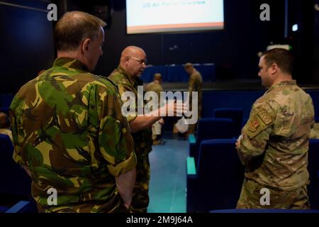 Service members from the Netherlands and the U.S. Air Force discuss topics relating to Explosive Ordnance Disposal at Ramstein Air Base, Germany, May 19, 2022. The 786th Civil Engineer Squadron EOD flight hosted U.S. Air Forces in Europe’s first EOD symposium to provide joint training with U.S. allies and, highlight topics such as the future of EOD and air base recovery. Stock Photo