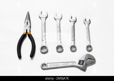 Spanish keys, pliers and stirson wrench on a white background Stock Photo