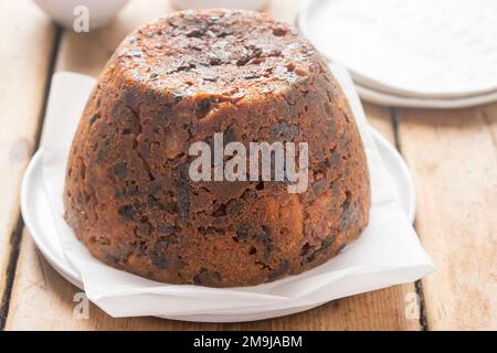 Christmas pudding. Irish boiled cake with cranberries, raisins and prunes. Stock Photo