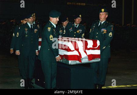 A US Army (USA) Honor Guard Team, from 1ST Battalion, 1ST Special Forces Group (Airborne) transports a flag draped transfer case carrying the remains of USA Sergeant First Class (SFC) Mark Wayne Jackson, on the flight line at Kadena Air Base (AB) Okinawa, Japan. SFC Jackson was assigned to A/Company, 2nd Battalion, 1ST Special Forces Group (SFG) (Airborne), Operational Detachment Alpha 142, and was killed during a bombing attack at an open-air restaurant, outside the gate at Camp Enrile Malagutay, Zamboanga, Philippines. (Substandard image). Base: Kadena Air Base State: Okinawa Country: Japan Stock Photo