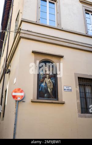 Florence, Italy - April, 15, 2022: Street shrine, known as Madonelle on street corner wall Stock Photo