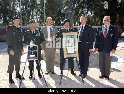 021107-F-5127B-003. [Complete] Scene Caption: US Army (USA) Soldiers assigned to the US Special Operations Command (USSOCOM), a family member and friends of Medal of Honor recipient USA Captain (CPT) Humbert Roque 'Rocky' Versace, pose for a group photograph during an Award Ceremony, held at the Special Operations Memorial, MacDill Air Force Base (AFB), Florida (FL). CPT Versace, whose picture appears foreground center, was posthumously awarded the Medal of Honor by Presidential declaration. Pictured left-to-right are, USA Lieutenant General (LGEN) Doug Brown, Deputy Commander, US Special Oper Stock Photo