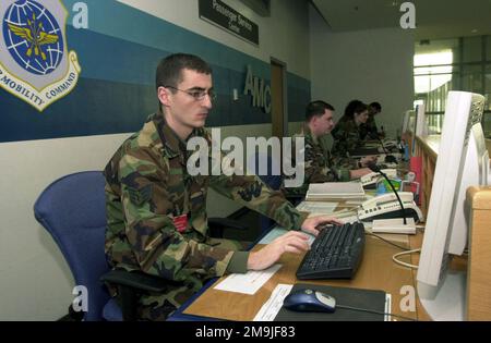 US Air Force (USAF) STAFF Sergeant (SSGT) Michael Jordan, Passenger Service Supervisor, 723rd Air Mobility Squadron (AMS), Ramstein Air Base (AB), Germany, works the customer service counter at the Air Mobility Command (AMC) passenger terminal. (Duplicate image, see also DFSD0412473 or search 021211F1851U007). Base: Ramstein Air Base State: Rheinland-Pfalz Country: Deutschland / Germany (DEU) Stock Photo