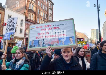 London, UK. 18th January 2023. Protesters march along Tottenham Court Road on their way to Downing Street. Nurses, NHS workers and supporters gathered outside University College Hospital for a rally in support of the NHS and nurses, as nurses across the UK continue their strikes. Credit: Vuk Valcic/Alamy Live News Stock Photo