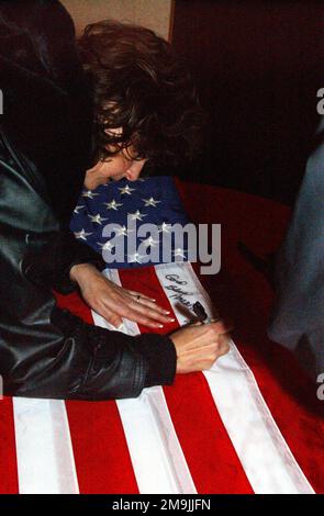 Dina Preston signs an American flag at the request of US Air Force (USAF) member, during a United Service Organizations (USO) concert for the 384th Air Expeditionary Wing (AEW), at a forward-deployed location, in support of Operation ENDURING FREEDOM. Subject Operation/Series: ENDURING FREEDOM Country: Unknown Stock Photo