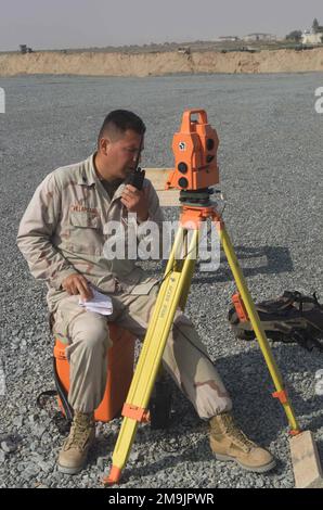 US Marine Corps (USMC) Sergeant (SGT) Villapizano, Marine Wing Support Squadron 373 (MWSS-373), uses a digital Theodolite to survey the lay of the land for a campsite at Al Jaber Air Base (AB), Kuwait, while deployed in support of Operation ENDURING FREEDOM. Base: Ahmed Al Jaber Air Base State: Al Ahmadi Country: Kuwait (KWT) Stock Photo