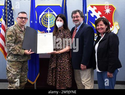 Lt. Col. Richard Baysinger, from left, 66th Air Base Group deputy commander, Heather Galante, principal of Bedford High School, and Philip Conrad, superintendent of schools in Bedford, and Laurel Wironen, installation school liaison officer, stand for a photo with a proclamation signed by Mass. Governor Charlie Baker during a presentation at Hanscom Air Force Base, Mass., May 19. The proclamation was presented to the Bedford school district in recognition of their support to military children. Stock Photo