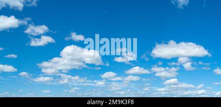 Cumulus clouds floating against blue sky Stock Photo