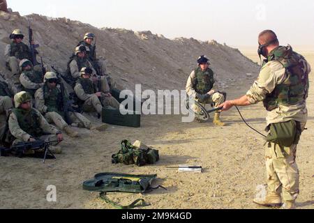 GUNNERY Sergeant (GYSGT) Keith Mrozinski demonstrates the proper use of ...