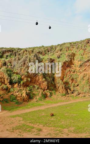 Empty cable cars on a windy day above the brown bear enclosure Cabarceno Natural Park Penagos Cantabria Spain Stock Photo