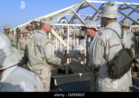 US Marine (USMC) Wing Support Squadron (MWSS) 373rd Commanding Officer (CO), Lieutenant Colonel (LCOL) Donald W. Zautcke introduces himself to the Marines building Camp Sledd's hardback tents at Ahmed Al Jaber Air Base, Kuwait, in support of Operation ENDURING FREEDOM. Subject Operation/Series: ENDURING FREEDOM Base: Ahmed Al Jaber Air Base State: Al Ahmadi Country: Kuwait (KWT) Stock Photo