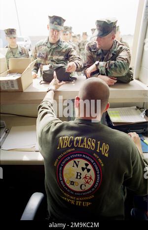 US Marine Corps Reserve (USMCR) personnel assigned to A/Company, 4th Light Armored Reconnaissance Battalion (LAR), are issued gas mask during Nuclear, Biological, Chemical (NBC) training in preparation for mobilization at Camp Pendleton, California (CA), in support of Operation ENDURING FREEDOM. Base: Marine Corps Base Camp Pendleton State: California (CA) Country: United States Of America (USA) Stock Photo