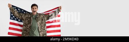 Wide Horizontal Banner With Happy Male Soldier Holding USA Flag In Hands Stock Photo