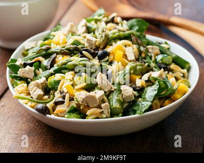 Home made asparagus, spinach orzo salad with vegan feta Cheese Stock Photo