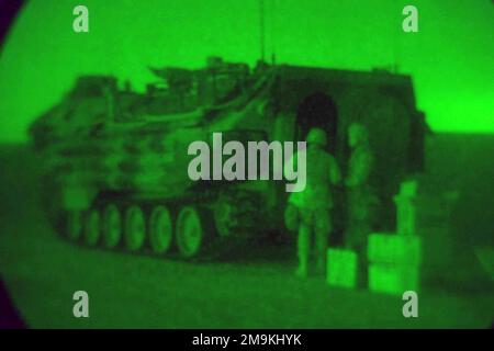 Nightscope view of US Marine Corps (USMC) Marines, 1ST Marine Division, Camp Pendleton, California (CA), supplying their AAV7A1 Assault Amphibian Vehicle at Camp Coyote in Northern Kuwait during Operation ENDURING FREEDOM. Base: Camp Coyote Country: Kuwait (KWT) Stock Photo