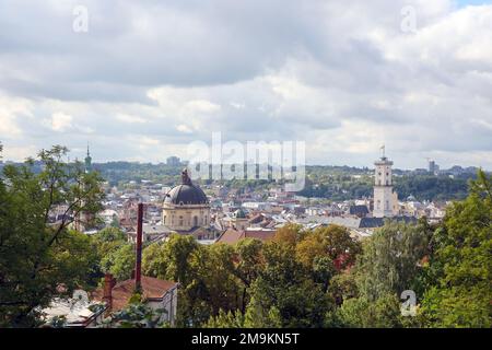 LVIV, UKRAINE - SEPTEMBER 11, 2022 Panorama view of the historical old city in Lviv, Ukraine. Many old buildings with metal roofs and cathedral domes in beginning of autumn day Stock Photo