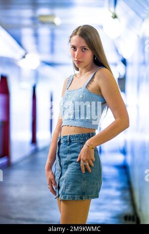 Pretty teenage girl standing against a white wall wearing leggings Stock  Photo - Alamy