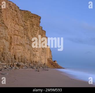 West Bay, Bridport, Dorset, UK. 18th Jan, 2023. UK Weather: The beach at the seaside resort of West Bay was closed today following a large landslip. A large pile of rocks could be seen on the beach leaving a scar in the cliff face made famous by the TV drama series Broadchurch. The honeycombe coloured rocks along this part of the Jurassic coast are known locally as being dangerous and prone to coastal erosion. Credit: Celia McMahon/Alamy Live News Stock Photo