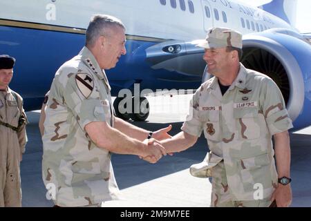 US Army (USA) General (GEN) Tommy Franks, Commander, US Central Command (USCENTCOM), is greeted by US Air Force (USAF) Brigadier General (BGEN) Rick Rosborg, Commander, 379 Air Expeditionary Wing (AEW) as he exits a USAF C-32A aircraft as he arrives at a forward deployed location is Southwest Asia. Country: Unknown Stock Photo
