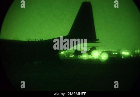 030322-F-9171L-010. [Complete] Scene Caption: A nightscope view of night operations near a US Air Force (USAF) MC-130H Combat Talon II, 1ST Special Operation Squadron (SOS), Kadena Air Base (AB), Okinawa, as a US Army (USA) CH-47 Chinook, 160th Special Operations Air Regiment (SOAR) comes in for a landing at Tague AB, Korea. The nighttime operations are part of RECEPTION STAGING ONWARD MOVEMENT and INTEGRATION (RSO&I), and FOAL EAGLE which are joint and combined exercises for soldiers, sailors, airmen and Marines. They gather in Korea to work hand-in -hand with their South Korean counterparts Stock Photo