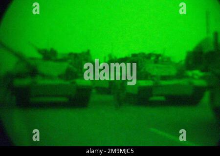US Marine Corps (USMC) M1A1 Abrams Main Battle Tanks (MBT) from Charlie Company, 1ST Tank Battalion, at a refueling position after dark in the vicinity of Al Nassaria, along route Tampa in support of Operation IRAQI FREEDOM. Subject Operation/Series: IRAQI FREEDOM Country: Iraq (IRQ) Stock Photo