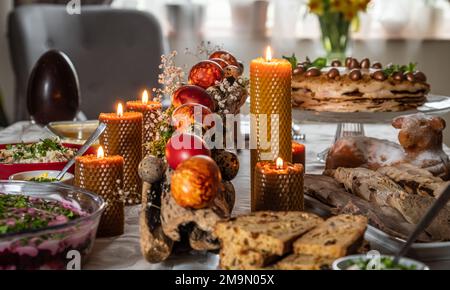 Easter feast with Easter eggs and candles on the festive table Stock Photo