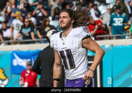 Baltimore Ravens punter Jordan Stout (11) follows through on a kick in the  first half of an NFL football game against the New England Patriots,  Sunday, Sept. 25, 2022, in Foxborough, Mass. (