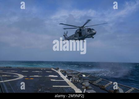 220520-N-DO281-1218   ATLANTIC OCEAN (May 20, 2022) A Royal Navy Merlin MK2 helicopter prepares to conduct a vertical replenishment with the Arleigh Burke-class guided-missile destroyer USS Paul Ignatius (DDG 117), May 20, 2022. Paul Ignatius is on a scheduled deployment in the U.S. Naval Forces Europe area of operations, employed by U.S. Sixth Fleet to defend U.S., Allied and Partner interest. Stock Photo