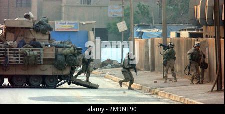 US Army (USA) Soldiers assigned to the 3rd Infantry Division dismount from a M2A2 Bradley Infantry Fighting Vehicle (IFV) to begin a reconnaissance security patrol and to assess damage done by looting to the Yarmuk Hospital, located in Baghdad, Iraq, during Operation IRAQI FREEDOM. Subject Operation/Series: IRAQI FREEDOM Base: Baghdad Country: Iraq (IRQ) Stock Photo